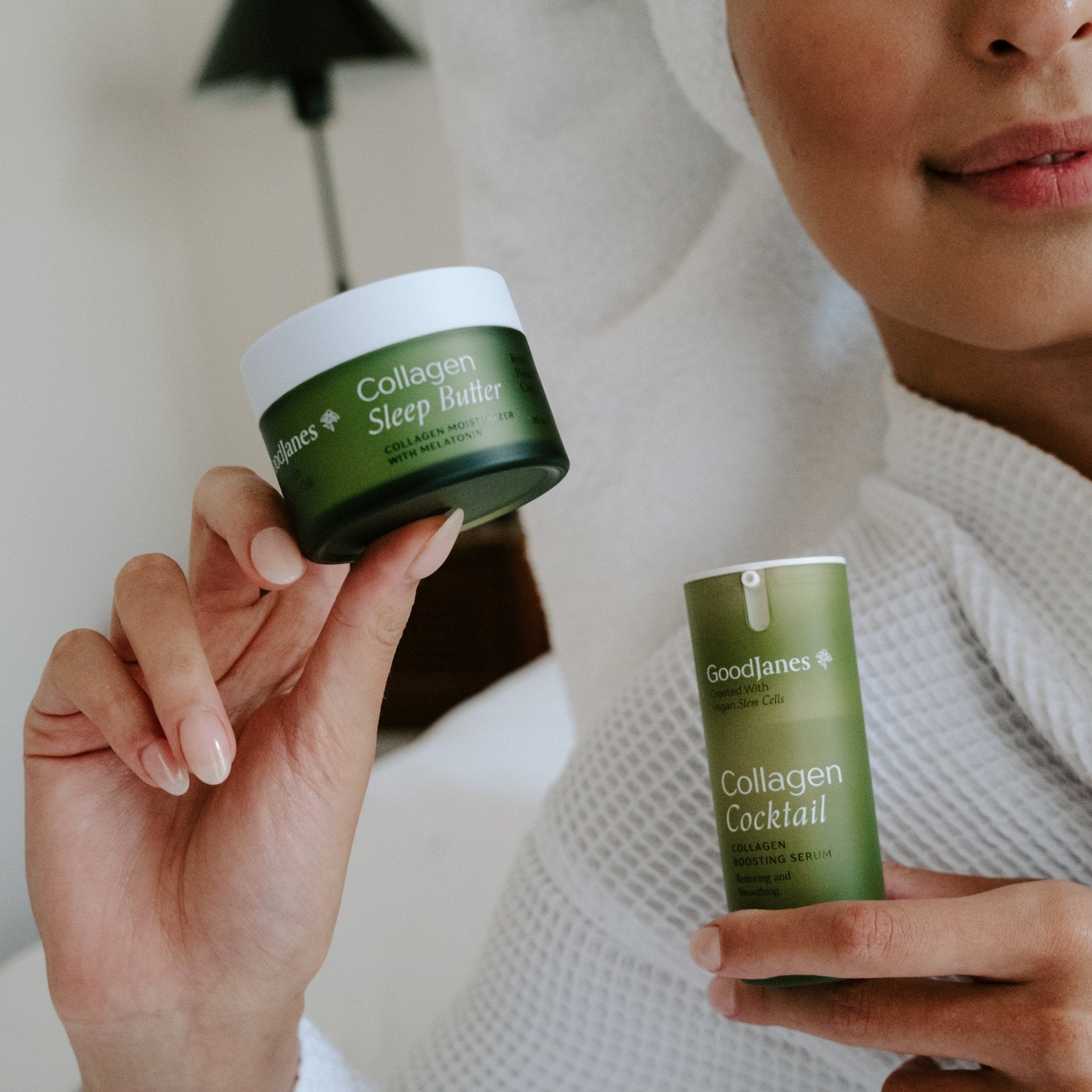 Person holding two green skincare products with 'Goodlines' branding.