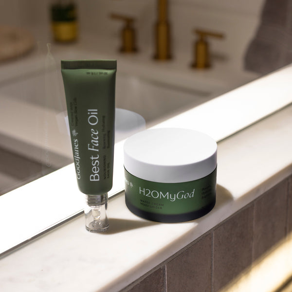 Two skincare products on a bathroom counter with a blurred background