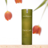 GoodJanes Face Latte serum bottle with blurred flowers in the background